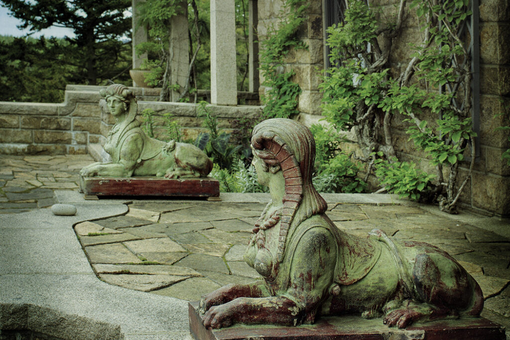 half woman half animal statues outside the house