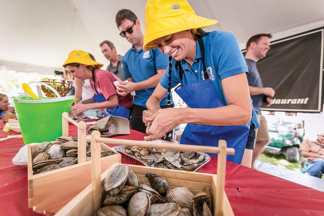 people shucking clams