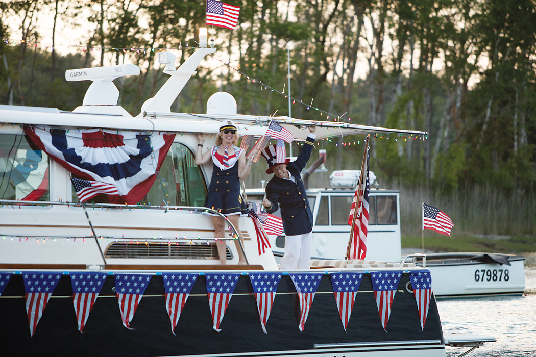 people dressed as sailors waving from boat