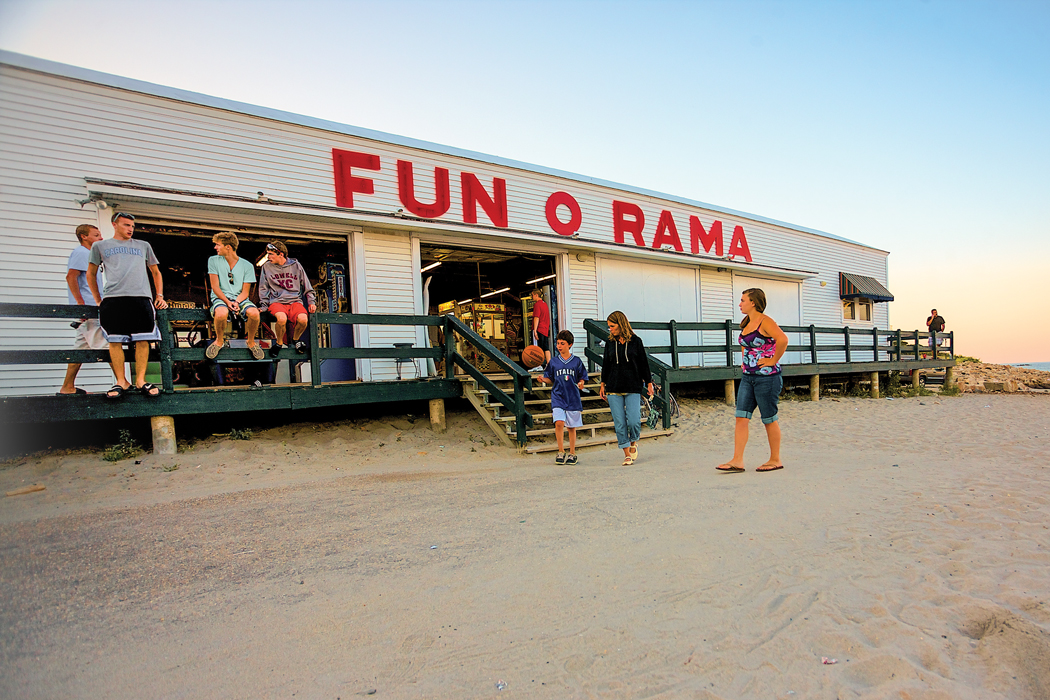 people around an arcade on the beach