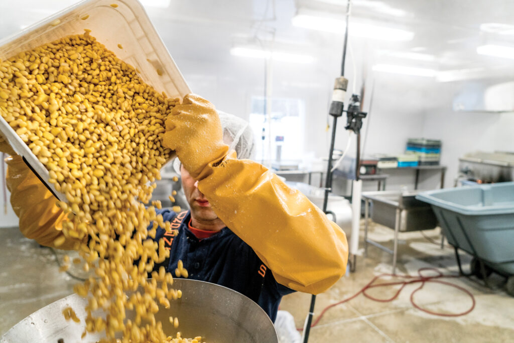 Jeff Wolovitz grinding organic soy beans for Heiwa Tofu